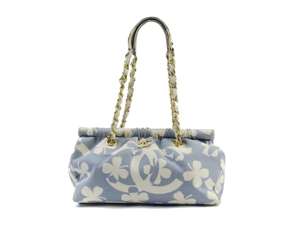 Lucky you to stumble upon a designer gem such as this! Whimsical four leaf clovers dance across the crisp light blue and white printed Chanel tote bag, anchored with large interlocking CC symbols and adorned with gold interlocking CC charm at front.