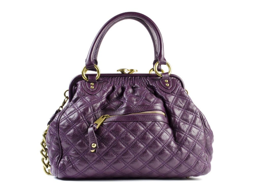 Own Marc Jacobs' stunningly structured Stam bag in the color of the year! Deep purple quilted leather satchel dons kisses of dark gold hardware for a royal look impossible to ignore. Clasp at top is stamped with MARC JACOBS in signature typeface.