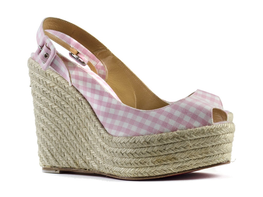 Perfect for spring! These Christian Louboutin Menorca espadrille wedges are the epitome of all things girly! These wedges feature a pink/white gingham print throughout, buckle closure. Heel measures approximately 5