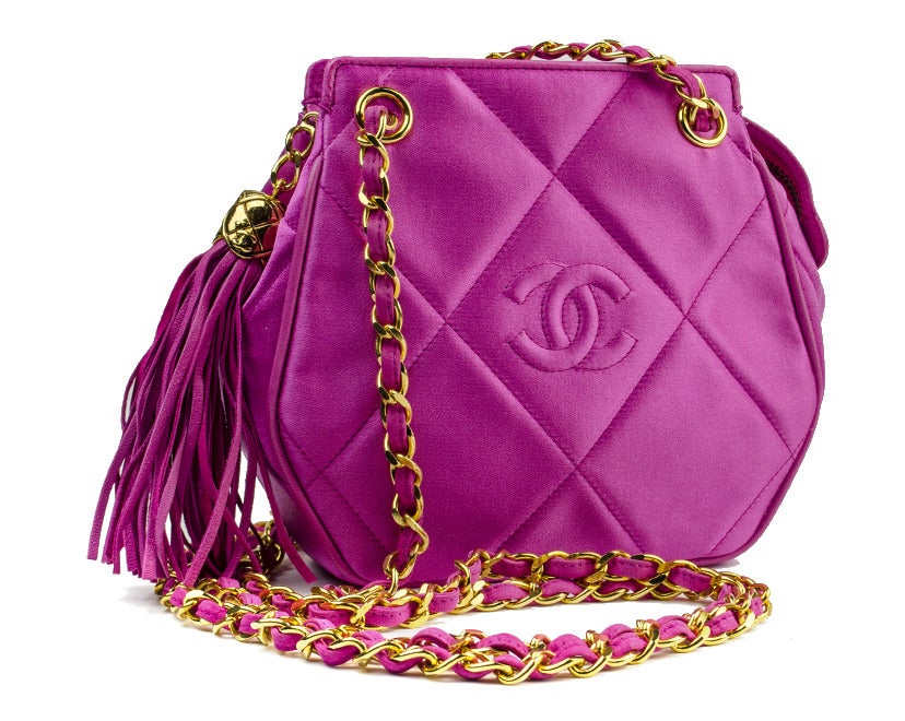 Ever so chic Chanel pink satin purse is perfect for any special occasion! This unique Chanel bag features hot pink satin throughout, interlocking ‘CC’ details at center of the bag, gold hardware, tassle detail at zip pull with CC gold hardware