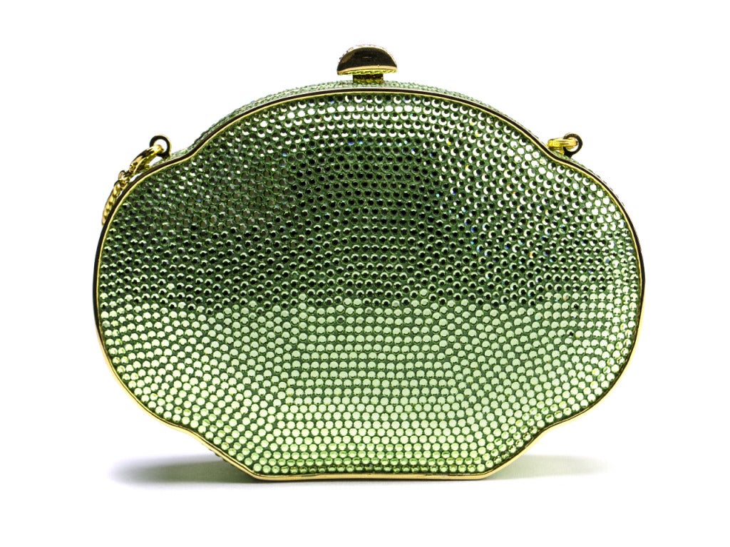 Every woman needs a little glitter in their life. This Judith Leiber clutch is perfect! She creates this Alhambra shaped clutch covered in green Swarovski crystals and gold accents; including gold hardware,crystal pushlock, chain link strap, and