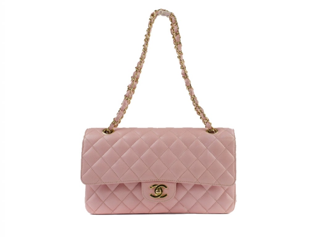 Chanel Double Flap 2.55 is expertly crafted of pink caviar leather gold tone hardware. Double flap with lock closure. Interior is stamped Chanel and line din pink leather with 5 pockets. Date code: 9196949. Measures approximately 9″ L x 6″ H x 2.5″