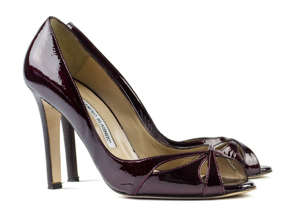 You'll have the whole ballroom smitten with a full skirted silhouette and the Manolo Blahnik 'Butterpump' heels. These dressy pumps in rich purple patent leather feature cutouts at vamp that create a butterfly-like shape and dark brown