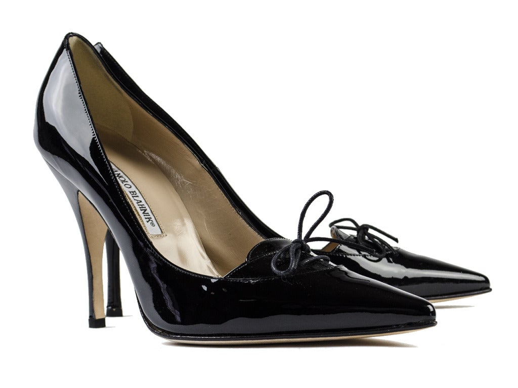 The Manolo Blahnik 'Kirby' heel is a combination of two classics: the black pump and the loafer. The pointed black patent leather pump features mini tongue laced with thin waxed dress laces, tied in a dainty bow at vamp. Pair with another combo of