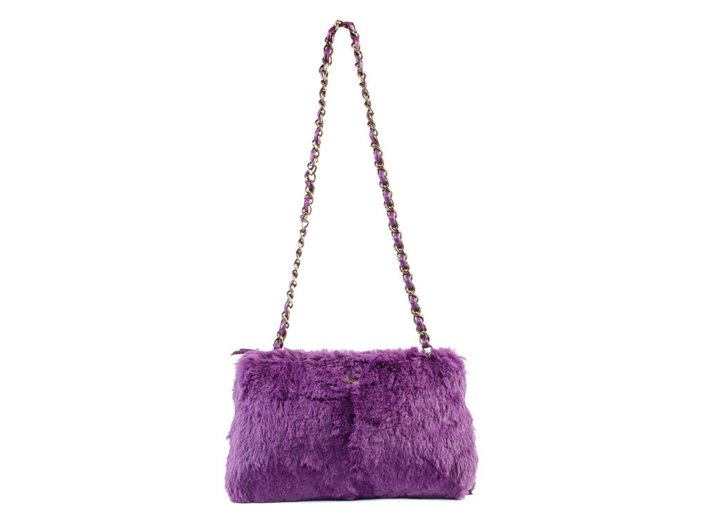 Be the trend setter you are with this super unique fur Chanel shoulder bag. It is covered in extremely soft purple fur, and has a leather with dark metal strap. Includes an authentication card with purchase. 

Dimensions: 11