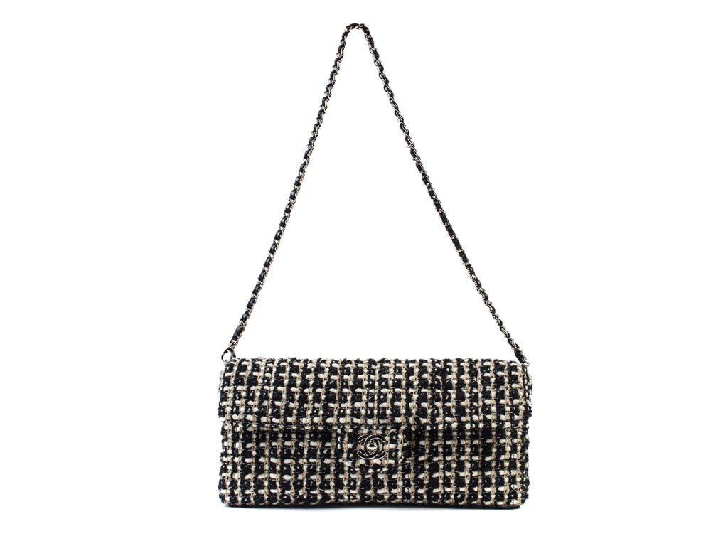 For the hard working woman with style, this is just the bag to make all your suits and professionalism stand out. The Chanel Tweed East West Flap takes a classic Chanel approach with a twist. The tweed is black, white and beige, with a little bit of