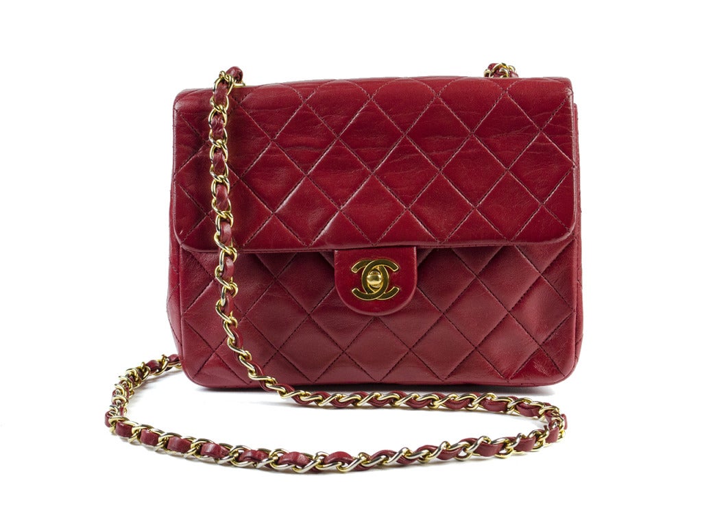 Express your passion for fashion and life with this vibrant red vintage Chanel bag! It is a traditional leather quilted style with gold accents. It is a square shape that is perfect for carrying around and looking fabulous. 

Dimensions: 8