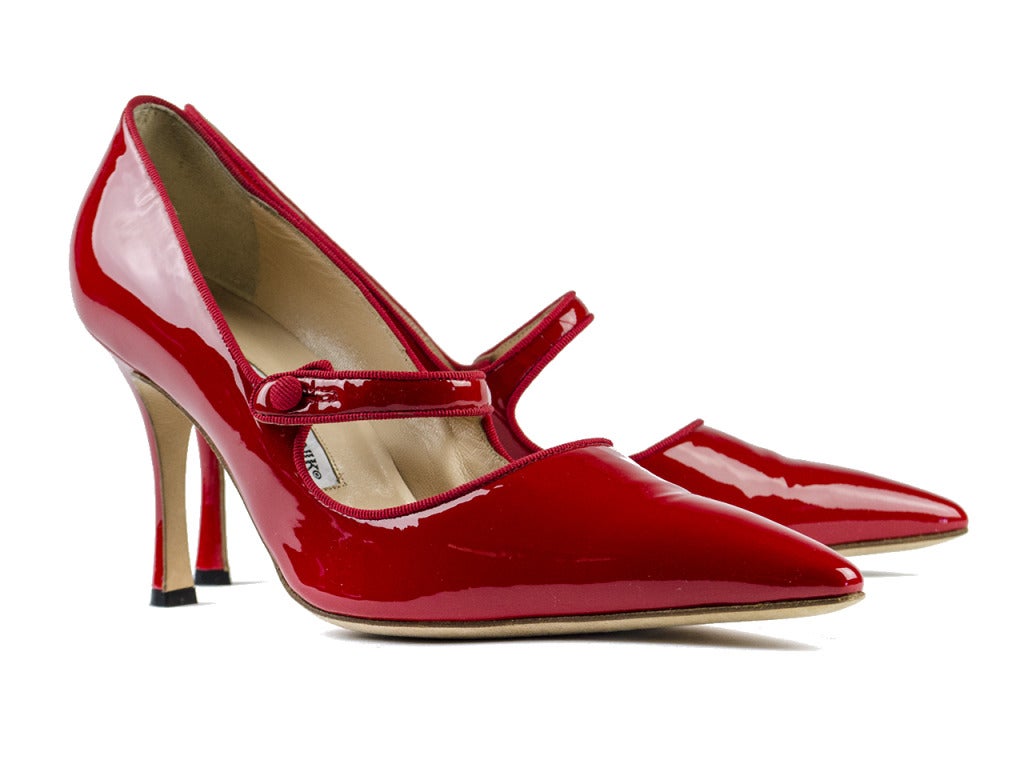 Heat up the sexy librarian look with cat eye specs, a crisp button-up blouse and the red hot Manolo Blahnik 'Campari' Mary Jane heels. Patent pointed toe pumps feature strap with button closure at middle of foot and textured cloth lining and button.