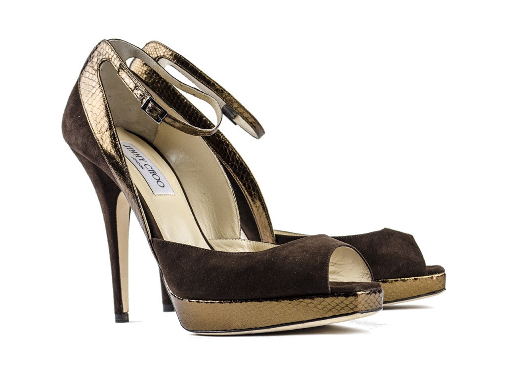 Seduce you most certainly will in the Jimmy Choo 'Seduce' brown watersnake heels. Bronze watersnake leather glides up the brown suede peep-toe heels from platform to ankle strap, striking with sophisticated sex appeal. 

Heel Height: 5