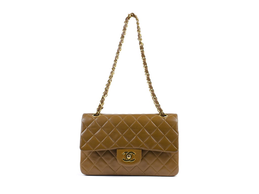 A tried and true classic, this Chanel vintage bag will never go out of style! Chanel double flap is of medium size in gorgeous lambskin leather, traditional diamond quilted pattern, double flap, one back pocket. Interior features three interior
