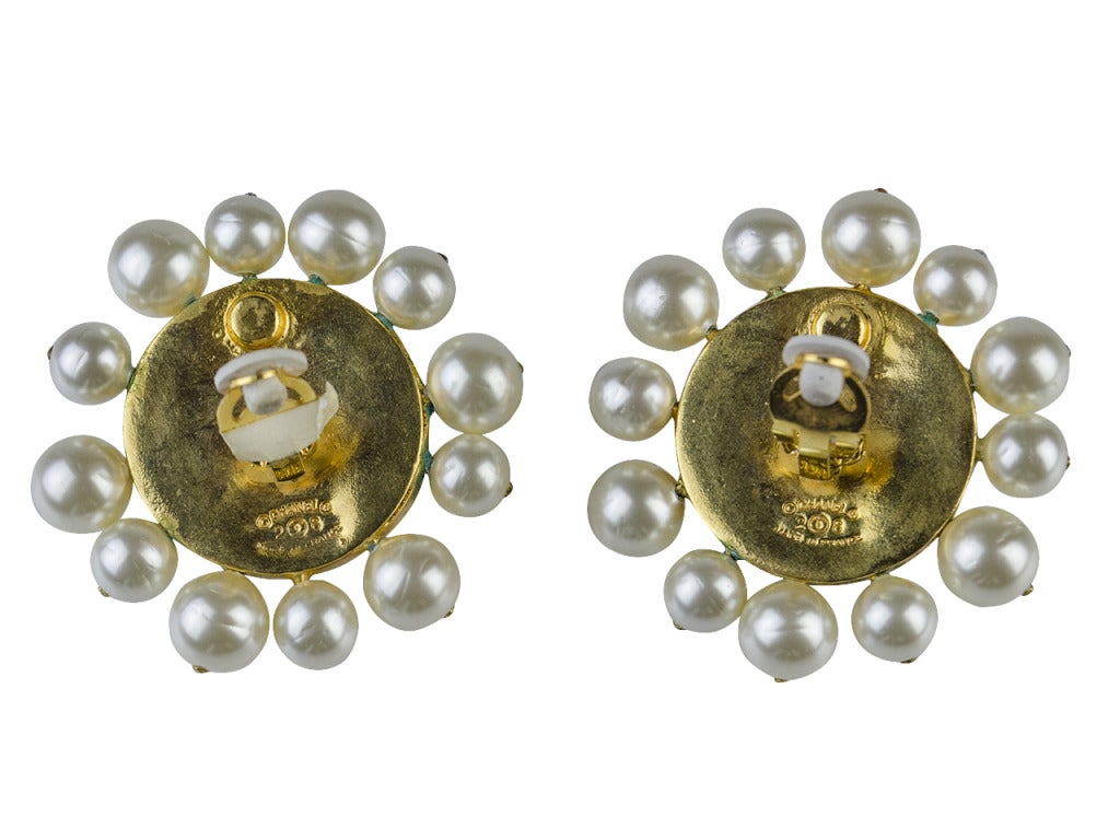 Dazzle them in the Chanel Season 28 glass and pearl earrings. Rippled clear glass at center shines with an opalescent sheen and pearls of varied sizes add classic elegance to outside. The type of earrings you always wanted to steal from the most