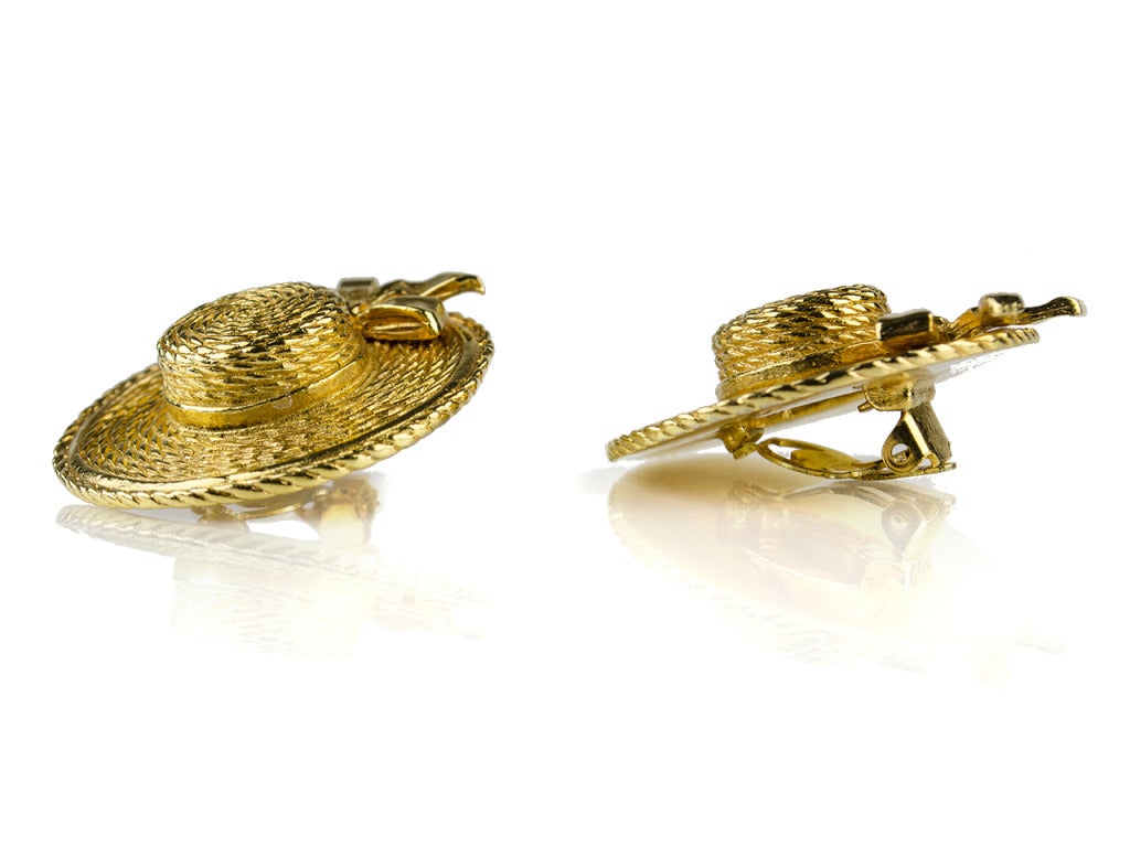 Don't leave the house without your Chanel bonnet(s)... On your ears, that is! From one of Chanel's 1970s collections, these yellow gold clip-ons grace your ears with straw bonnets finished with pretty bows. They'll have you looking sweet as pie when