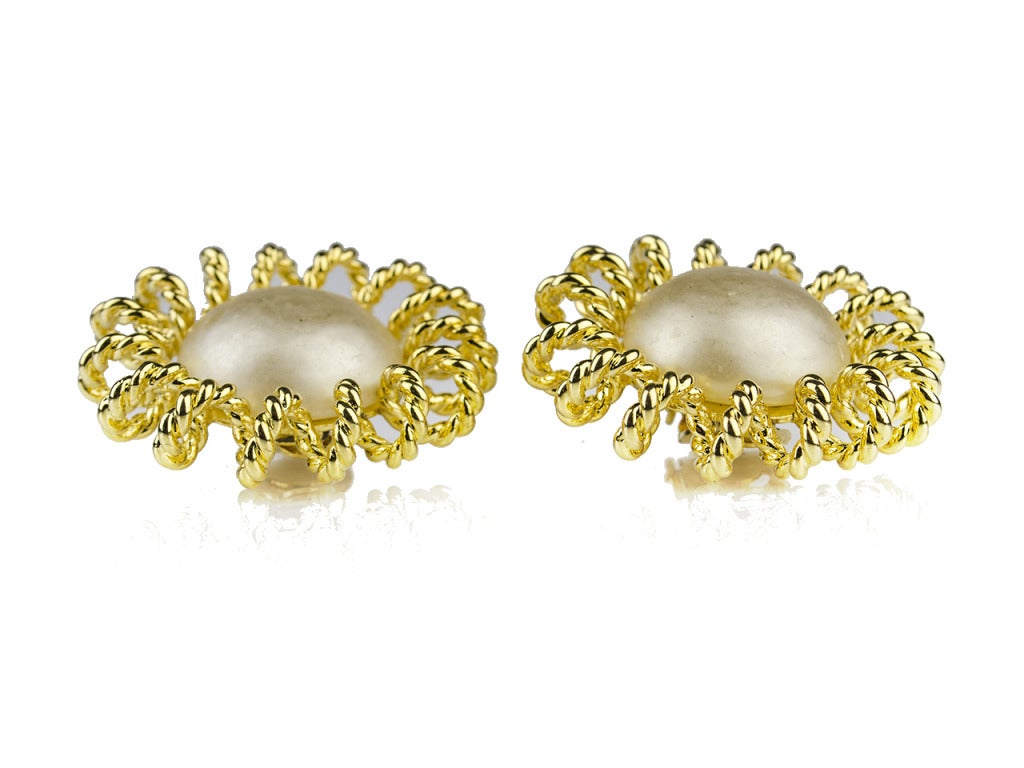 Starbursts of classic pearl and bright yellow gold instantly illuminate your work and play wardrobes. The vintage Chanel Season 25 pearl earrings feature large pearls outlined with twisted yellow gold, looped into a shape reminiscent of the flowers
