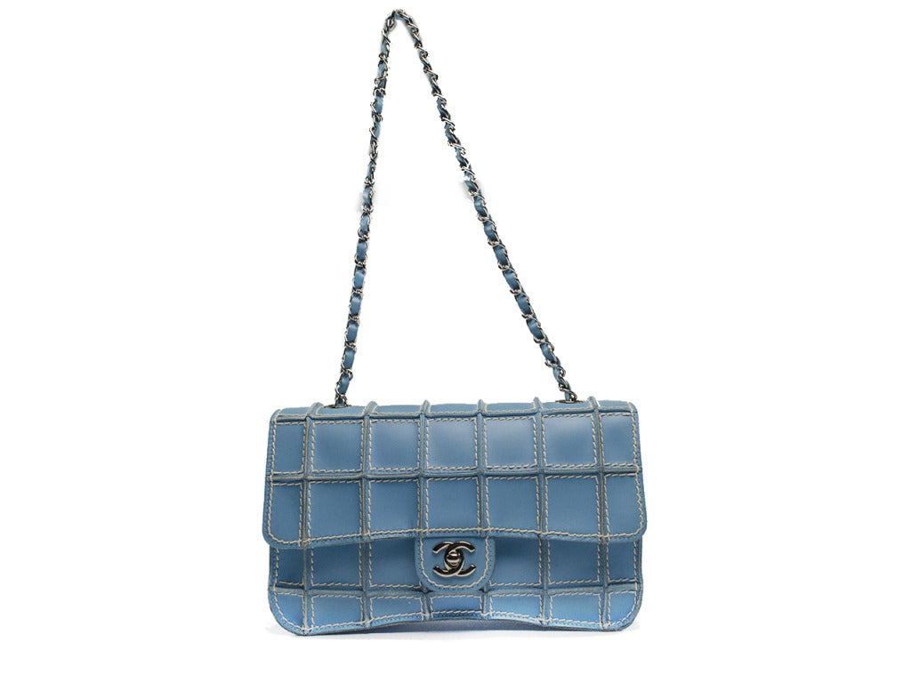 Such a rare find! This Chanel flap will be sure to turn heads! Featured in a light blue with contrasting white stitching, traditional Chanel 'CC' logo located at the front, silver tone hardware. Interior features smooth leather and one pouch