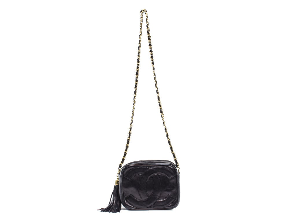 Head into festival season in style! This Chanel crossbody is a must have in any fashionistas wardrobe! This bag features black lambskin leather throughout, gold tone hardware, black lambskin leather and gold tone crossbody strap, fringe tassel