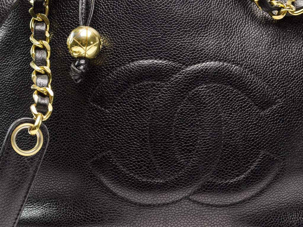 The perfect tote for any Chanel fan! This tote is a sure classic that your closet will never wear out! This bag features black iconic Chanel 'CC' details at the front of the bag, double strap leather handles, Chanel zipper pull and gold tone