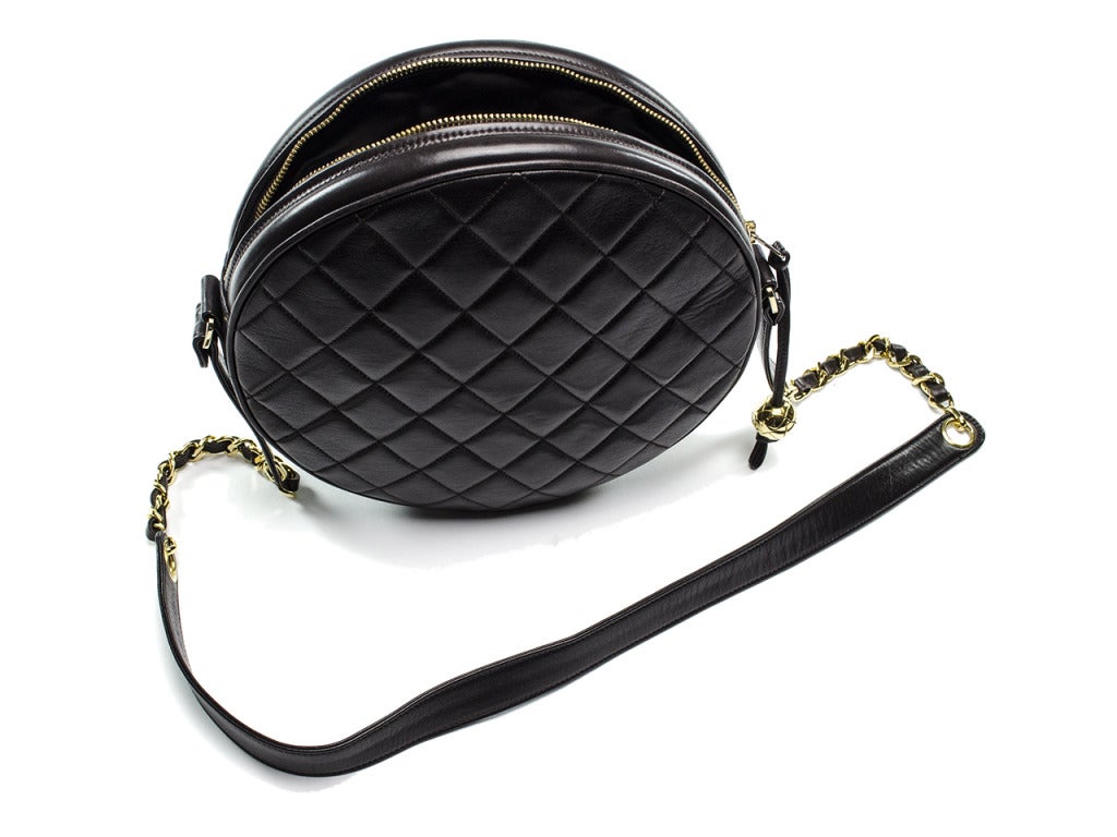 Add a bit of funk to your wardrobe with this fun Chanel round bag--perfect for festival season or just to stand out from the crowd! This bag features quintessential diamond pattern throughout, leather handle with gold chain detailing, zipper pull