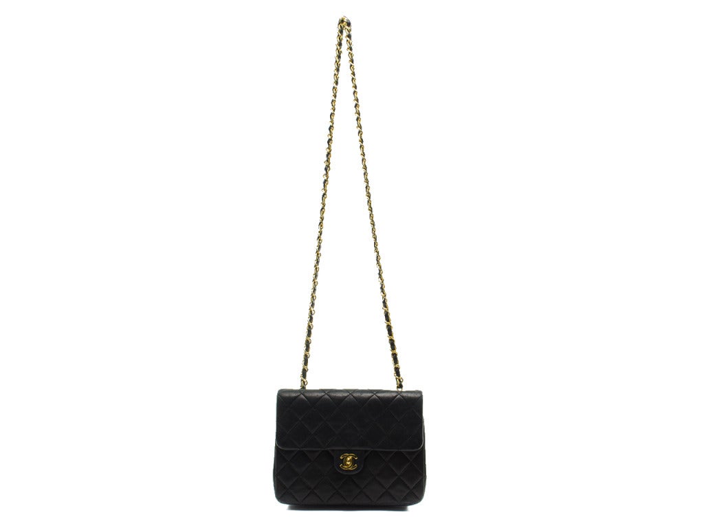 The perfect addition to any Chanel collectors closet this classic mini is sure to stand the test of time. This bag features quintessential diamond pattern throughout, black lambskin leather, gold tone hardware. Interior features one zippered pocket