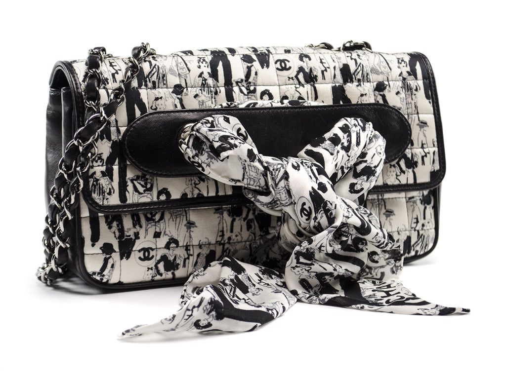 Perfect for any Chanel fanatic! This Chanel black & white silk Coco Madmeoiselle Scarf bag is perfect for carrying the daily must haves! The exterior features a fun yet flirty design with CC logo, scarf detail, classic leather and chain entwined