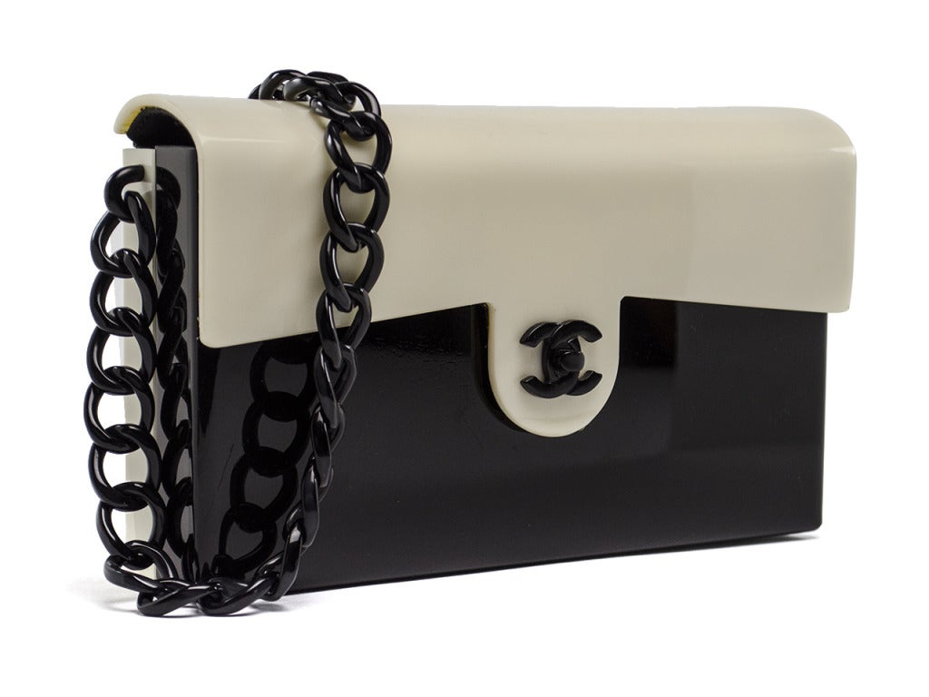 Super chic meets mod Chanel resin flap is unlike any Chanel bag in your collection! This bag features a hard resin casing throughout, black plastic chain detail, Chanel 'CC' stamp at front of the bag. Interior features one zipper pocket. Date Code: