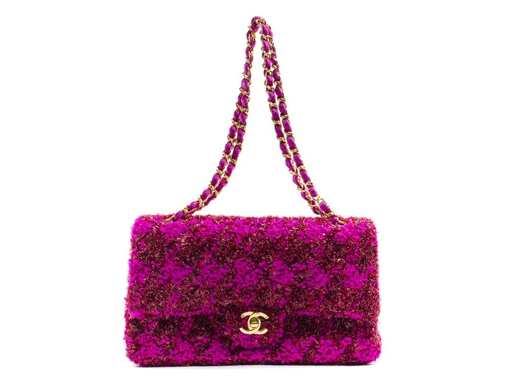 Extremely rare! Chanel monochromatic pink tweed flap will be sure to set you apart from the crowd! This bag features fuchsia and red tweed detailing throughout, gold tone hardware, one black pocket. Interior features one pouch pocket and one