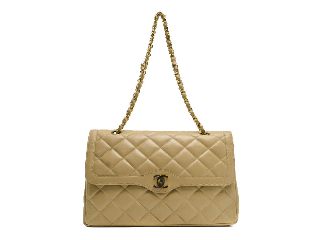 Buttery soft & easy to wear with anything this Chanel flap will be your go to piece! This Chanel bag features beige lambskin leather throughout, quintessential diamond pattern throughout, silver & gold tone mixed hardware throughout, iconic Chanel