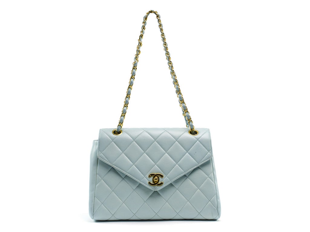 The perfect bag to accent your Easter Sunday's best! This Chanel vintage lambskin flap bag is constructed in heavenly robin's egg blue quilted leather, featuring an envelope shape, yellow gold interlocking CC at turn-lock and yellow gold,