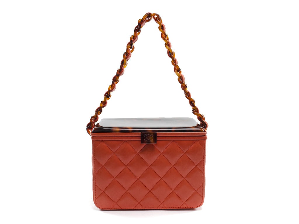 A true work of handbag art. The rare Chanel vintage lambskin box bag features the uber-chic combo of orange quilted lambskin leather and tortoise shell plastic, a beautiful way to tie a neutral olive or nude dress and your favorite tortoise shell