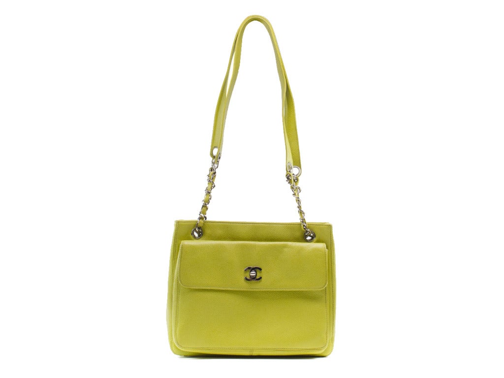 This hot yellow-green vintage Chanel tote is available just in your time for your spring and summer escapades! Drop your sunscreens and lip balms into this yummy caviar leather tote, slip it over your shoulder and head off into the sun. Featuring