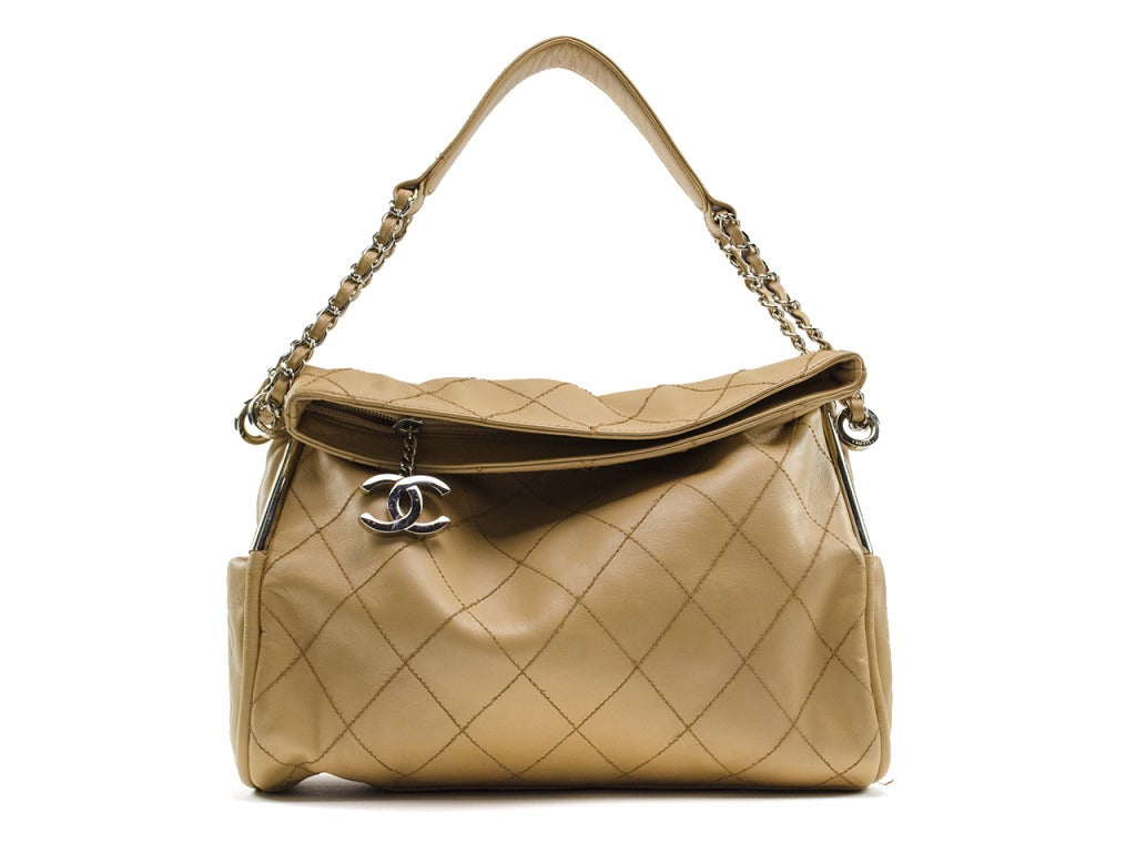 On-trend yet classic, just like your personal style! Dress the Chanel cross-stitched lambskin hobo bag up with a pencil skirt or down with a pair of jeans... you really can't go wrong with this flirty neutral piece. The fold-over slouchy bag with