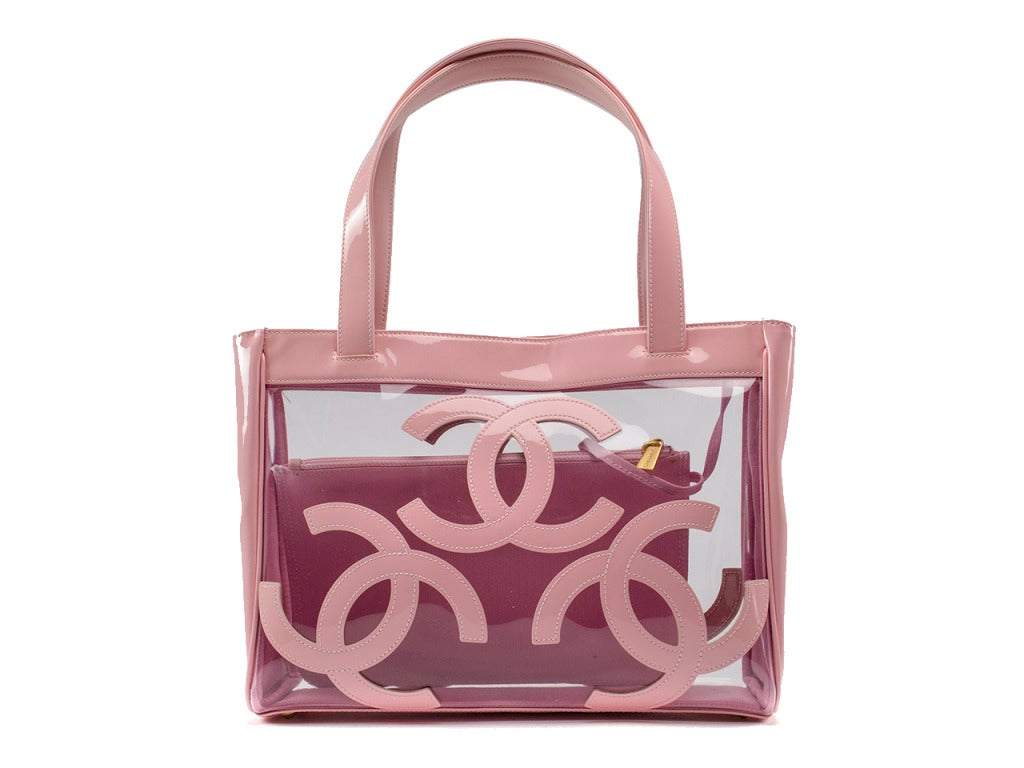 Accessorize your ruffle bikini with this pretty pink poolside tote! The Chanel triple CC logo clear vinyl tote is spacious enough for all of your fun-in-the-sun must haves and chic enough to carry your polished personal style into all of the