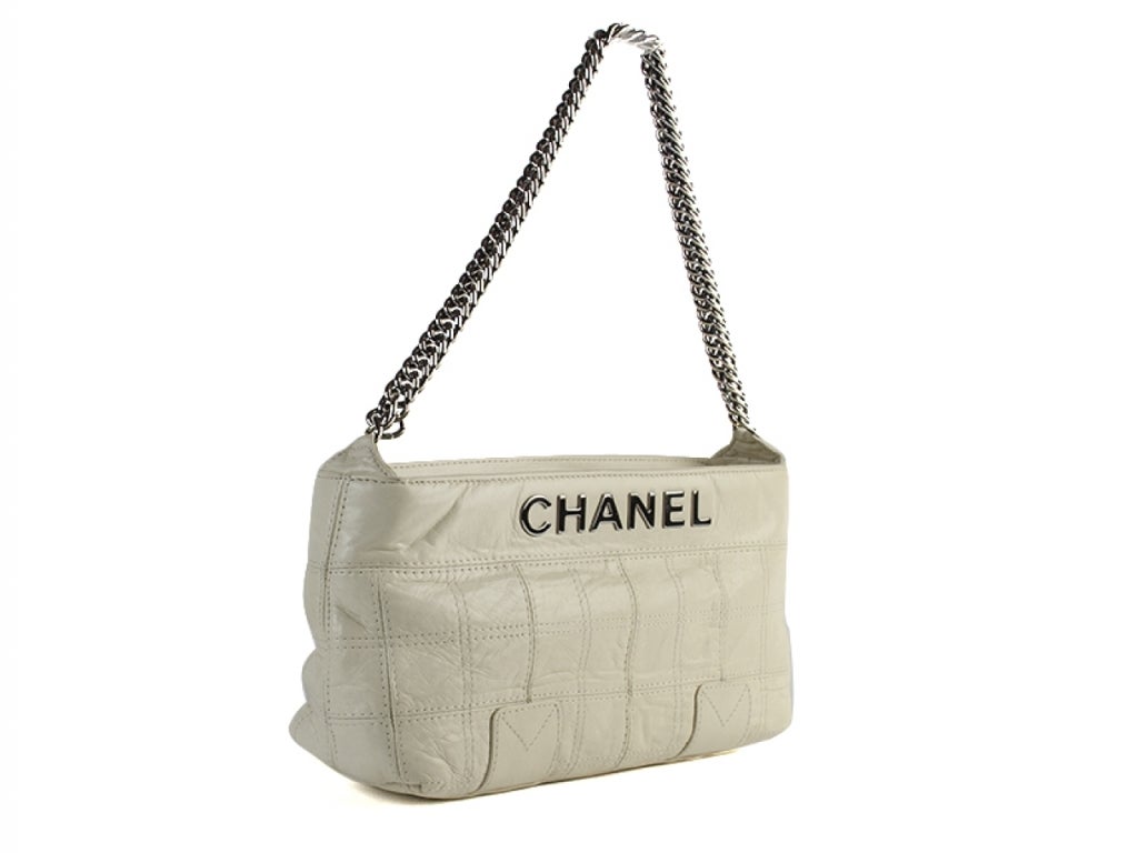 Brand New! Ever so chic & stylish Chanel ivory quilted leather LAX East-West shoulder bag is perfect for everyday! This bag features gorgeous quilted calfskin leather with a bold CHANEL logo, zip top, one interior pouch pocket. Date code: 11862246. 