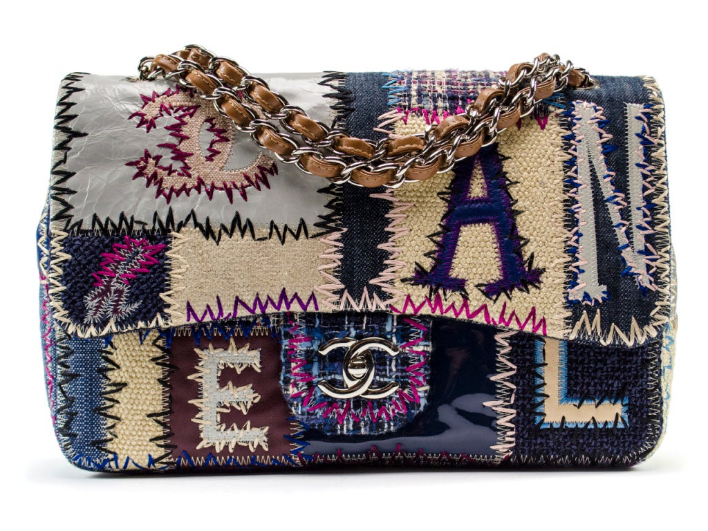 A limited edition Chanel with kitschy chic charm. This jumbo flap features a multi-textured patchwork body in denims, leathers and tweeds with letters spelling out CHANEL stitched in, silver interlocking CC turn lock charm and silver and cognac