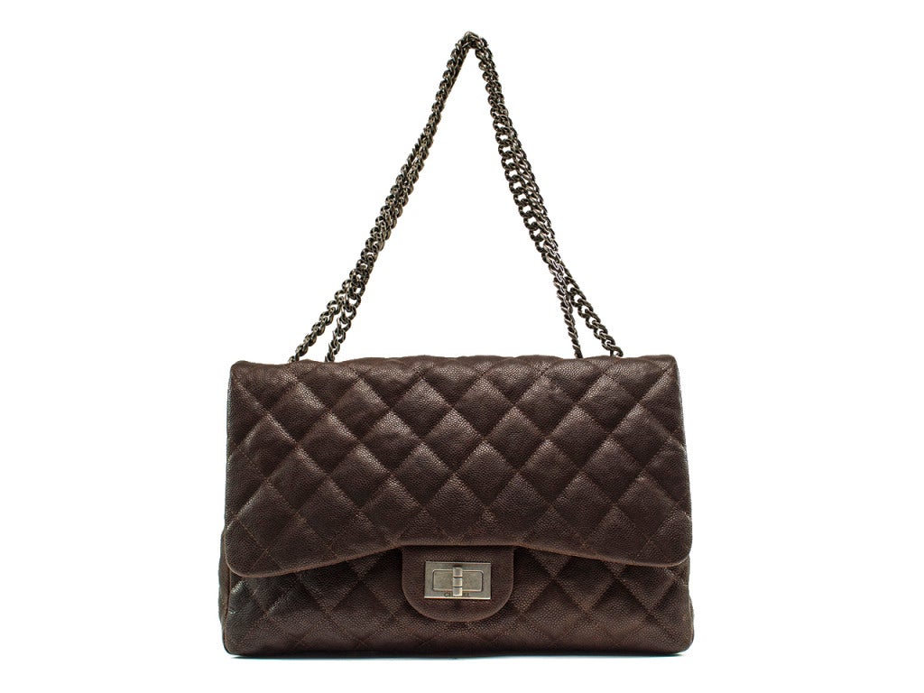 Chocolate brown quilted Caviar leather with a glimmering sheen and understated hardware accents - the perfect neutral yet rich addition to your bag collection. The Chanel brown Caviar Reissue flap bag features turn lock stamped with CHANEL in