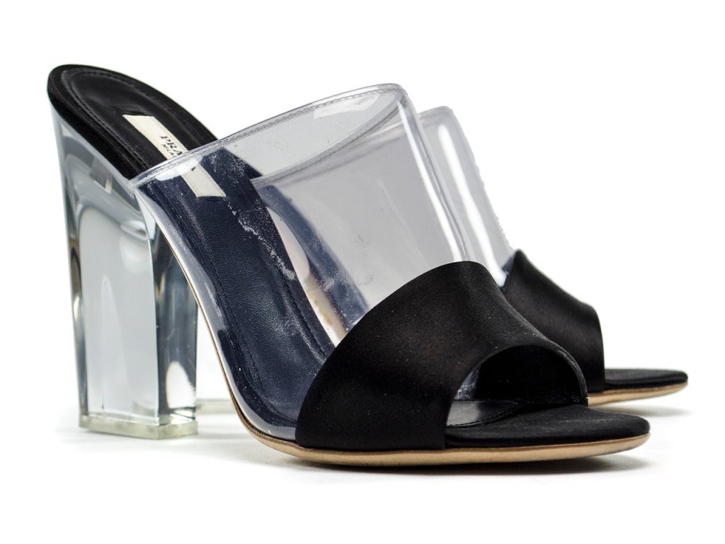 Rock the Prada clear lucite and black satin mule sandal heels with a slinky black dress or jean shorts... Either way they are so in and just scream summer luxury. Black satin is added to the vamp and insole of chunky lucite heeled mule sandals and