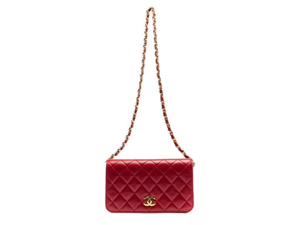 Extremely rare & hard to find this tomato red Chanel flap will have you doing black flips! This gorgeous flap is featured in red lambskin leather, quintessential diamond pattern throughout, gold tone hardware with interlocking 'CC' detail at the