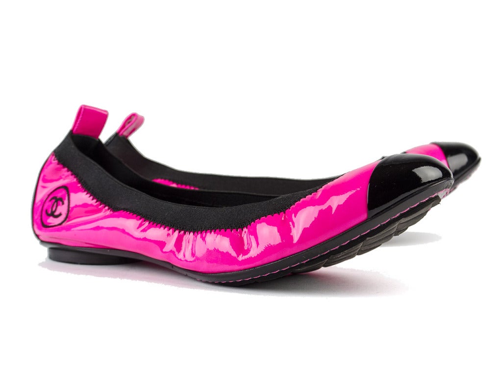 Updated in a fun loving neon pink this quintessential Chanel ballerina flat takes on a whole new life! Extremely hard to find Chanel black and pink patent leather flats will quickly become your go to flats! Condition: These shoes are in excellent