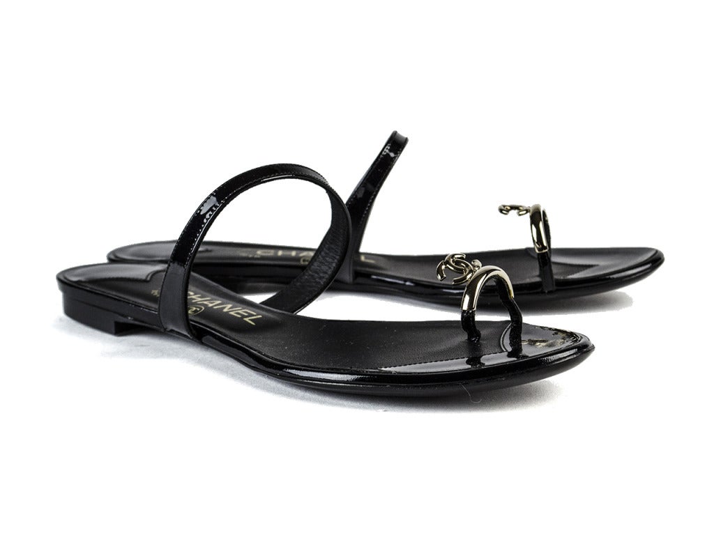 Add a little pep in your step with these fun Chanel sandals. Black rubber throughout with Chanel interlocking ‘CC’ detail in silver hardware at toe. In good pre-owned condition.