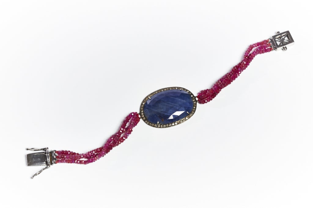 Jade Jagger oval blue sapphire, ruby bead and diamond bracelet. Sterling silver with black rhodium plate.