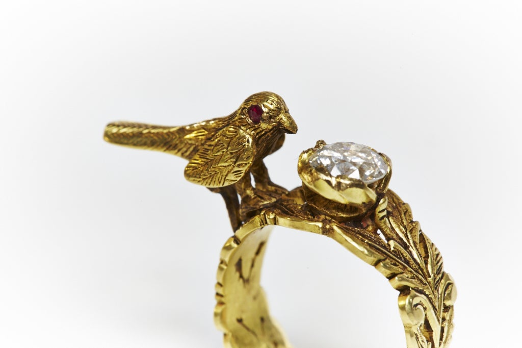 Exquisite, conversational hand-carved ring featuring small bird with ruby eyes drinking from a pool-like diamond of 0.7 carats. The underside of ring features and carved flower set with a ruby at its centre. All in 18k gold.
Size 6.5