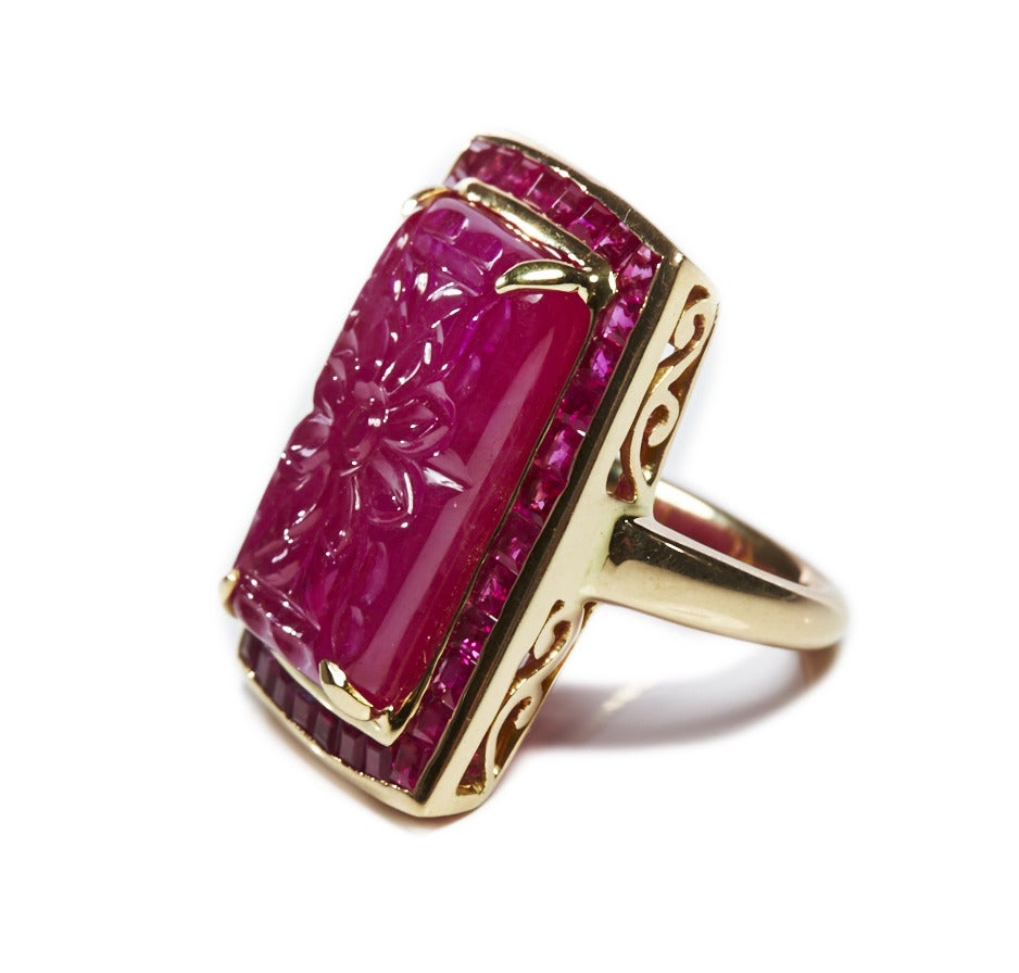 Jade Jagger rectangular carved ruby ring with channel set ruby surround. 18k Gold
Size 6.75