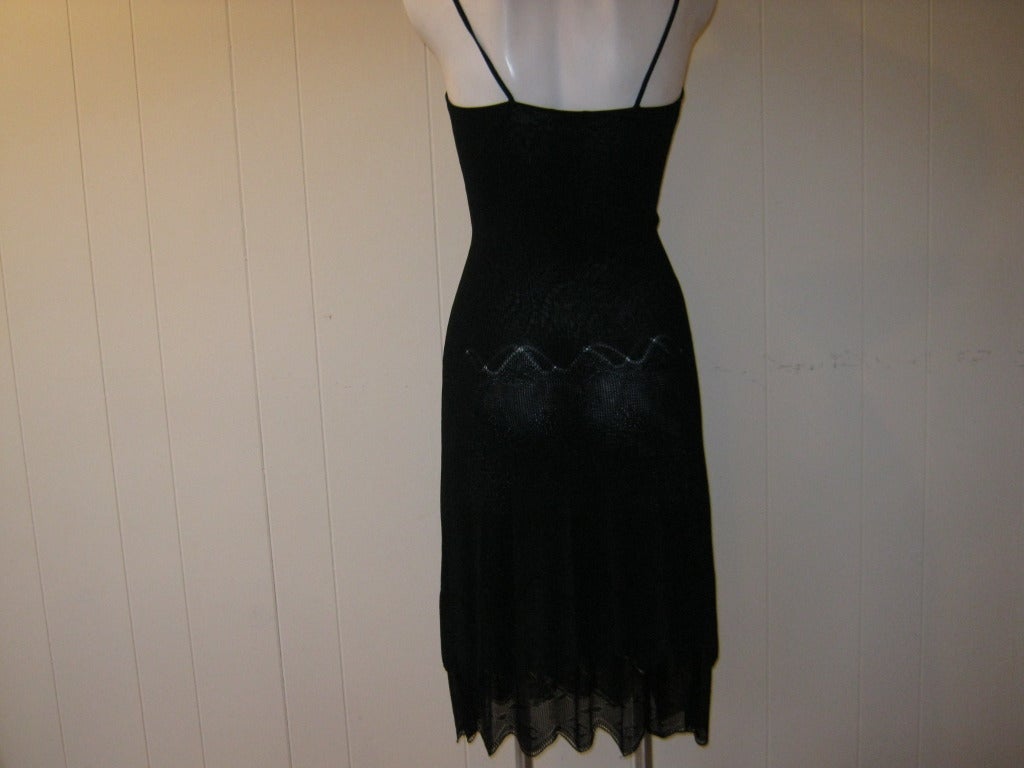 This 2003 Cruise Collection Chanel black dress is very wearable whether for a night out or a special occasion. Pay special attention to the scalloped edges and the design. Reminiscent of the 1920s style.

The dress is marked 36 (fr) but has give