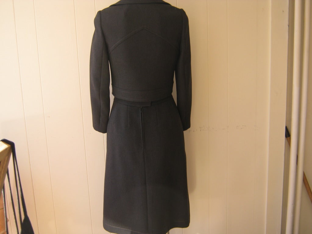 This suit, which is hand finished, is typical 60s Pierre Cardin with a short tailored jacket with a double flap collar and a skirt with a slight A-line.

The wool is of a heavy weave which allows for a very fitted look. Although dated from the