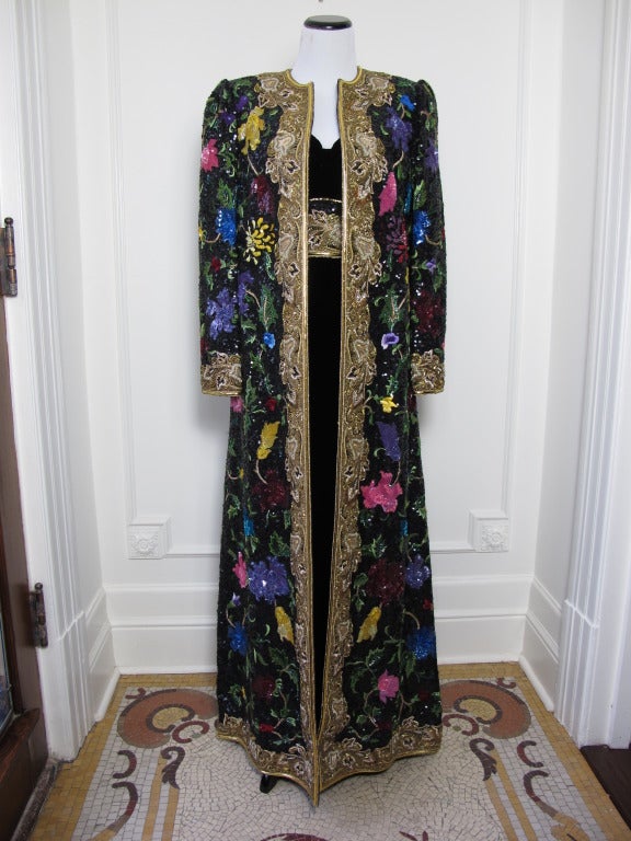 Gold and multi-coloured embroidered long coat….vintage at its finest. Hailing from a Parisian socialite's wardrobe this unique and stunning piece was made to make a luxurious statement. Elegant and rare this coat is perfect attire for a true