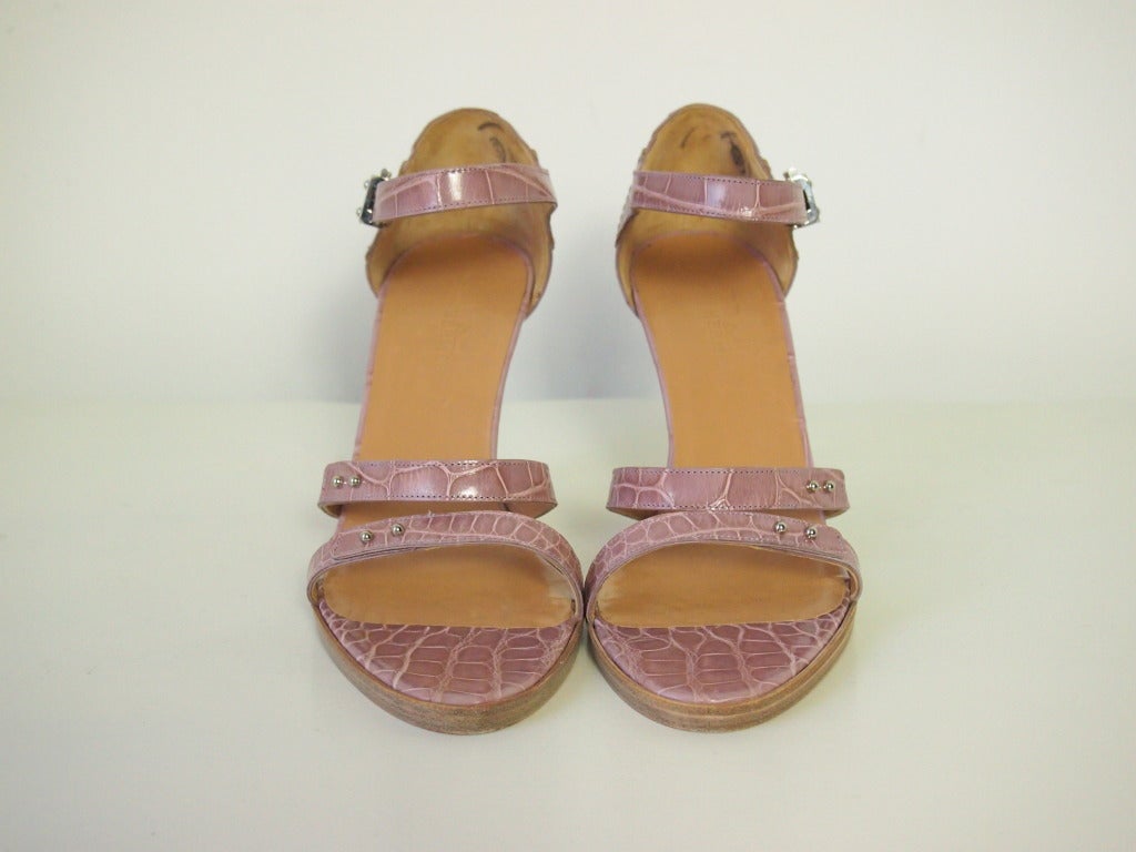 Hermes: exquisite, luxurious and feminine Ornella shoes in a gentle lilac crocodile. These strappy shoes have a stacked heel with the Hermes signature hardware in palladium. The perfect shoe to pack when heading to the sun as they are sexy,