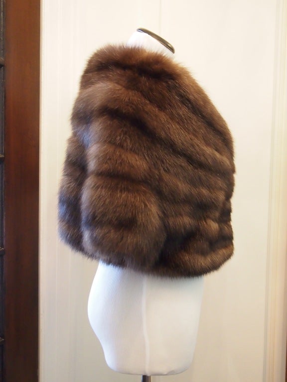 This exquisite fur shrug from Zandra Rhodes is the ultimate in luxury. The sable is a five row fur with soft and full texture. The colours are rich, in chocolate and black. Originally $35,000.

The unique feature is that it is an elegant,