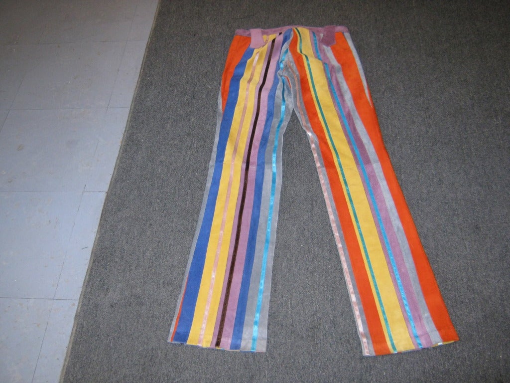 These rainbow colored striped suede pants will stand out in any crowd. Although there are belt loops, you can choose whether to were one or not. The suede individually stitched stripes are supplemented by interspersed colorful satin bands.

There