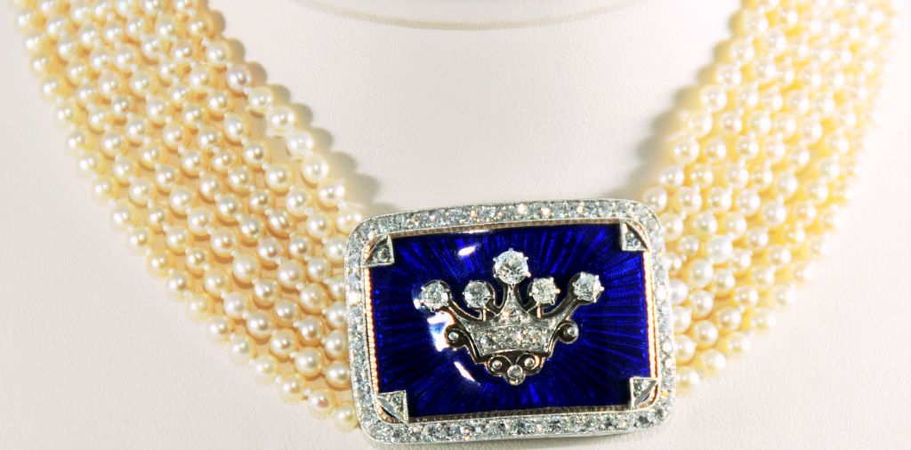Edwardian Cobalt Guilloche Enamel and Diamond Crown Plaque on seven strands of Natural Pearls with Platinum and Diamond Clasp.<br />
Platinum on 15k Gold.