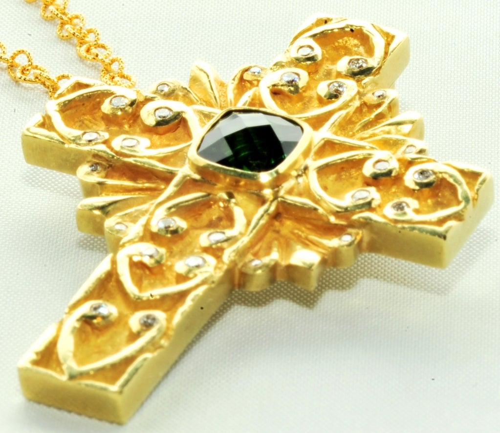 Heavily Carves 18k Green Tourmaline and Diamond Cross Pendant.
Designed by Kelly Brown and Made in her Workshop in a 17th Century Hacienda near San Miguel de Allende Mexico
Signed: Kelly Brown