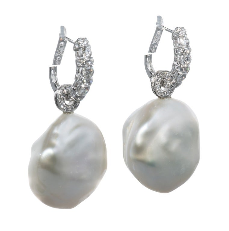Extra Large South Sea Button Pearl Earrings on Diamond Huggie Loops
in 18 k white gold with diamond huggies 1.2 cts.